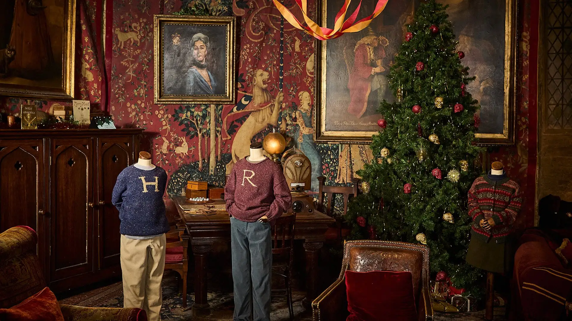 Hogwarts in the Snow - the Gryffindor common room set dressed for Christmas with the iconic 'R' and 'H' jumpers on display