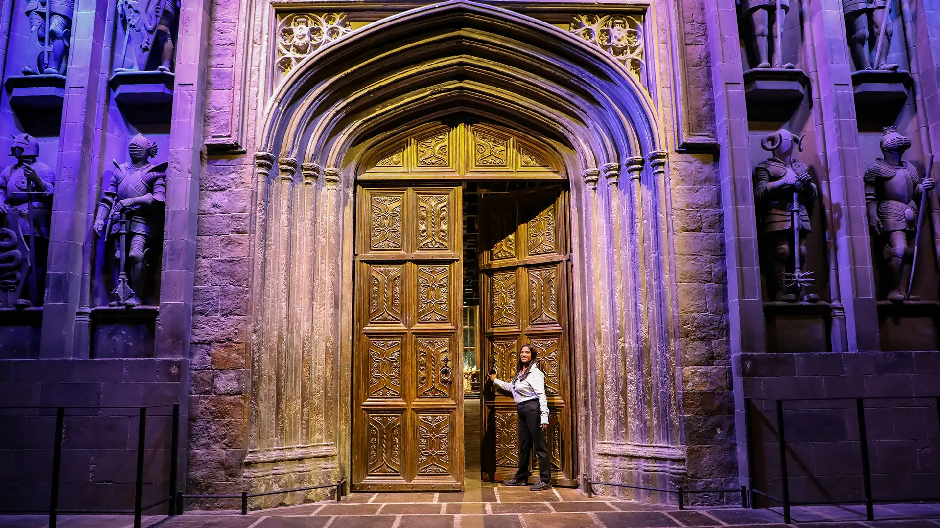 An Interactor opening the doors to the Great Hall set