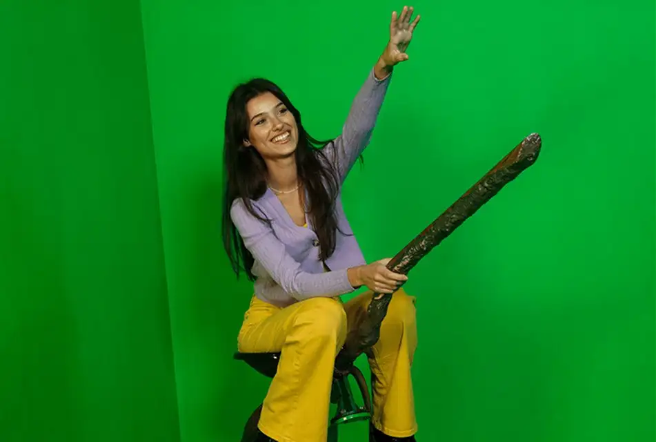 Visitor sat on a Broomstick at the Green Screen Experience