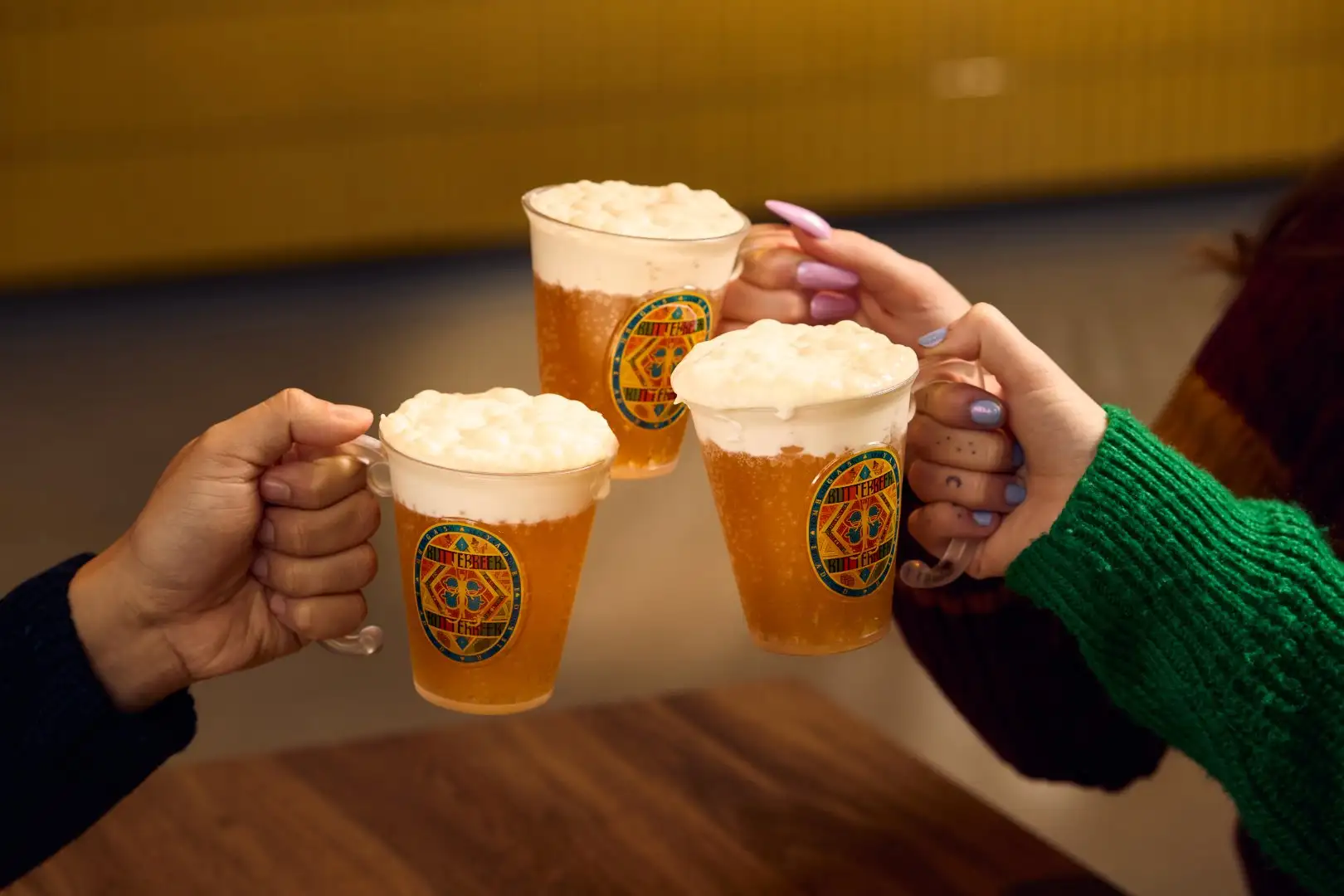Guest clinking Butterbeer cups in the Butterbeer Bar